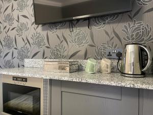 a kitchen with a counter with a coffee maker on it at Number 53 in Girvan