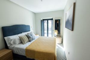 Postel nebo postele na pokoji v ubytování Apartamentos El Patio Plaza Mayor Cáceres