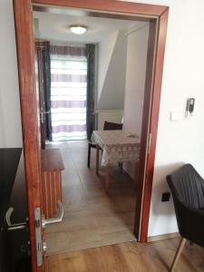 a door leading into a dining room with a table at Anita Apartman in Bük