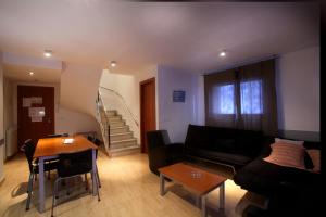 a living room filled with furniture and a couch at Apartaments Turístics Prat de Les Mines in Ordino