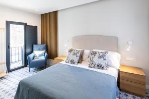 Postel nebo postele na pokoji v ubytování Apartamentos El Patio Plaza Mayor Cáceres