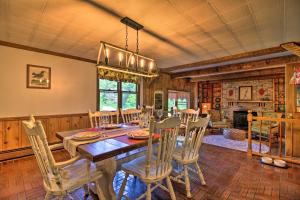 a dining room with a table and chairs at Vintage Schroon Lake Farmhouse w/ Private Beach! in Schroon Lake