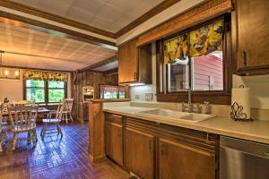 a kitchen with a sink and a table at Vintage Schroon Lake Farmhouse w/ Private Beach! in Schroon Lake +27 photos