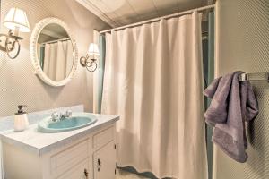 a bathroom with a sink and a shower curtain at Vintage Schroon Lake Farmhouse w/ Private Beach! in Schroon Lake
