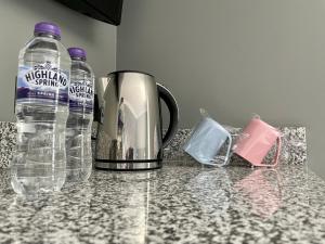 a kettle and two bottles of water on a counter at Number 53 in Girvan