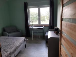 a bedroom with a bed and a desk and a window at Siedlisko Błotnia in Mierzeszyn +67 photos