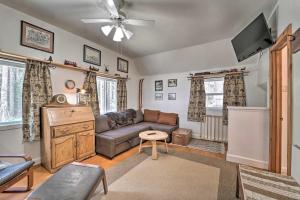 a living room with a couch and a tv at Rustic Soda Springs Cabin Less Than Half-Mi to Ski Resort in Soda Springs