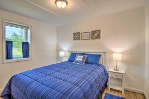 A bed or beds in a room at Cozy Central Lake Cottage about 3 Mi to Lake Michigan!
