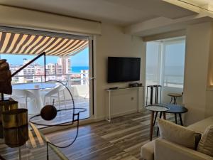 a living room with a view of the ocean at Ático Zeus in Gandía