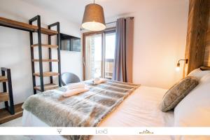 ein Schlafzimmer mit einem Bett in einem Zimmer mit einer Leiter in der Unterkunft MARMOTTE 005 - Splendide appartement avec terrasse, aux pieds des pistes in Bonneval-sur-Arc
