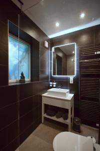 a bathroom with a white sink and a mirror at Jordan Suite Executive Furnished Apartment in Düsseldorf