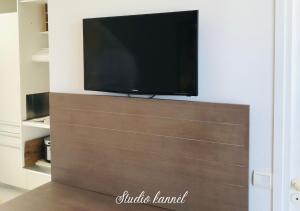 een flatscreen-tv bovenop een entertainmentcentrum bij Charmant studio Kannèl au MANGANAO vue sur mer et panier d'accueil offert in Saint-François