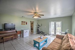a living room with a couch and a piano at Lake Okeechobee Fishing Retreat with Fire Pit! in Clewiston