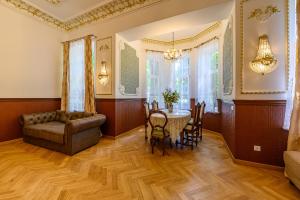 a living room with a couch and a table at Komodora nams in Liepāja