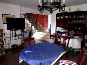 a dining room with a blue table and a staircase at Picturesque Villa in Chulilla with Private Pool in Chulilla