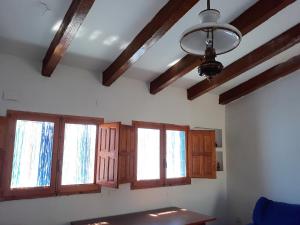 a living room with wooden ceilings and windows at Picturesque Villa in Chulilla with Private Pool in Chulilla +41 photos