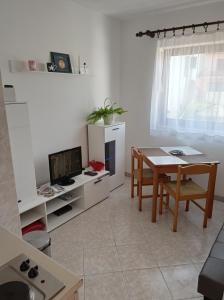 a living room with a table and a dining room at "Sunny" - Studio Apartment in Pula