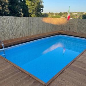 a swimming pool on a deck with a fence at La casa di Colino e Annina in Monopoli