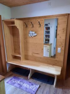 a wooden cabin with a shelf and a mirror at Naturidyll Brunner in Köstendorf