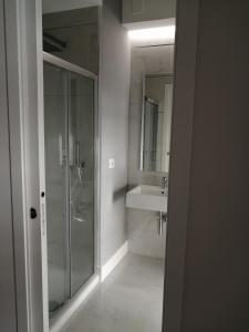 a bathroom with a glass shower and a sink at Insieme al mare in Praia a Mare +25 photos