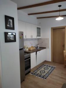 a kitchen with a refrigerator and a stove top oven at Apartman Lora in Budva