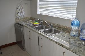 a kitchen counter with a sink and a window at Piece of Paradise in Hermanus +5 photos