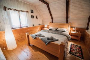 a bedroom with a bed with two towels on it at Postaja Mir in the heart of Triglav National Park in Bohinj