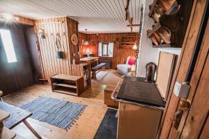 a kitchen with a refrigerator and a stove in a room at Postaja Mir in the heart of Triglav National Park in Bohinj