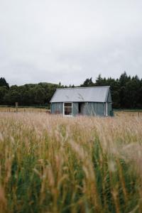 a barn in the middle of a field of grass at The Field House in Fort Augustus