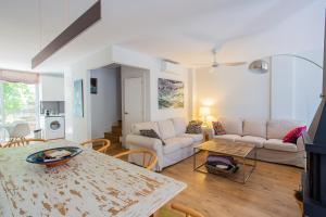 ein Wohnzimmer mit einem weißen Sofa und einem Tisch in der Unterkunft CASA CON ENCANTO in Cabo de Palos