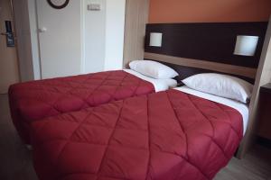 Uma cama ou camas num quarto em Premiere Classe Roissy Aéroport Charles De Gaulle