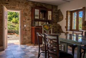 a dining room with a table and chairs at Casa Rural Castillo JABUGO in Jabugo