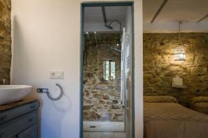 a bathroom with a shower and a sink in a room at Casa Rural Castillo JABUGO in Jabugo +30 photos