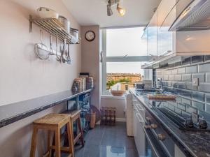 a kitchen with a counter and a large window at Pass the Keys Stunning 1BD flat in City Centre in Edinburgh