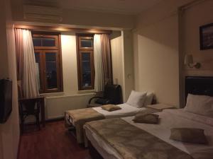 A bed or beds in a room at Taksim House Suites
