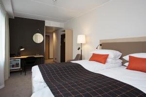 Habitación de hotel con 2 camas y escritorio en Scandic Meyergården en Mo i Rana