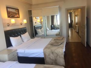 A bed or beds in a room at Taksim House Suites