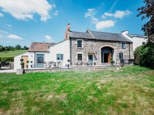 an exterior view of a stone house with a yard at Pass the Keys Stunning Large 4 Bed Country House with Hot tub in Bath