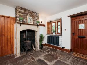 a living room with a stone fireplace and a door at Pass the Keys Stunning Large 4 Bed Country House with Hot tub in Bath