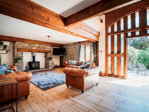 ein Wohnzimmer mit Ledermöbeln und einem Kamin in der Unterkunft Pass the Keys Stunning Large 4 Bed Country House with Hot tub in Bath