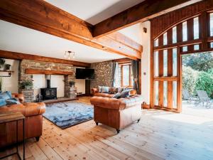 a living room with leather furniture and a fireplace at Pass the Keys Stunning Large 4 Bed Country House with Hot tub in Bath