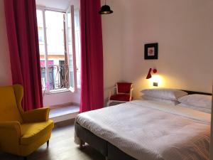 a bedroom with a bed and a chair and a window at DAB Guest House in Rome