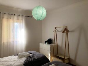 a bedroom with a bed and a green lamp at Charming Villa in Resende with Private Pool in Resende +34 photos
