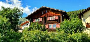 a large wooden house in the middle of trees at B&B Chalet Della Torre in Molare