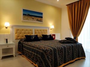 a bedroom with a large bed in a room at Falli Exclusive Rooms and Breakfast -Boutique B&B- in Porto Cesareo