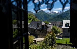 a view from a window of a village with mountains at Hotel Rural Casa Dera Hont in Arrés