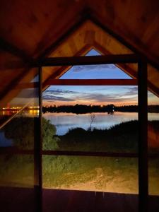 a view of a lake from a window at Osmolicka Chatka in Ryki