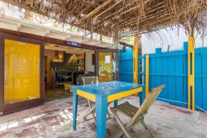 a blue table and two chairs on a patio at Beach Studio Flaka at Lac Bay in Kralendijk