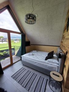 a bedroom with a bed and a large window at WIOSKA RUSIŃSKI in Bukowina Tatrzańska +68 photos