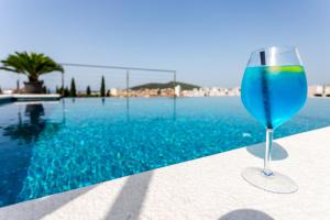 a blue wine glass sitting next to a swimming pool at Art Hotel in Split